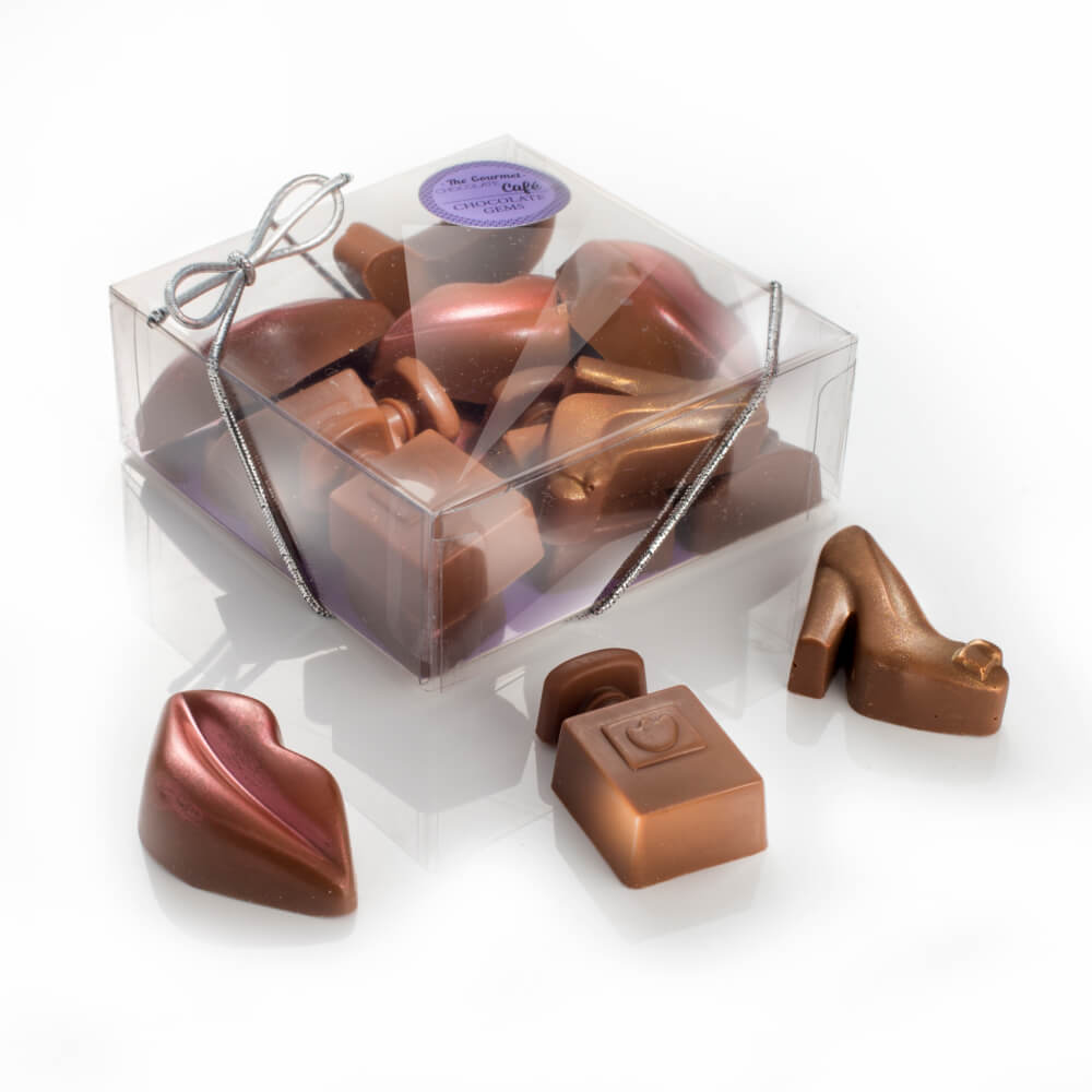 A box of little chocolate essentials including chocolate lips, perfume bottles and high heels.